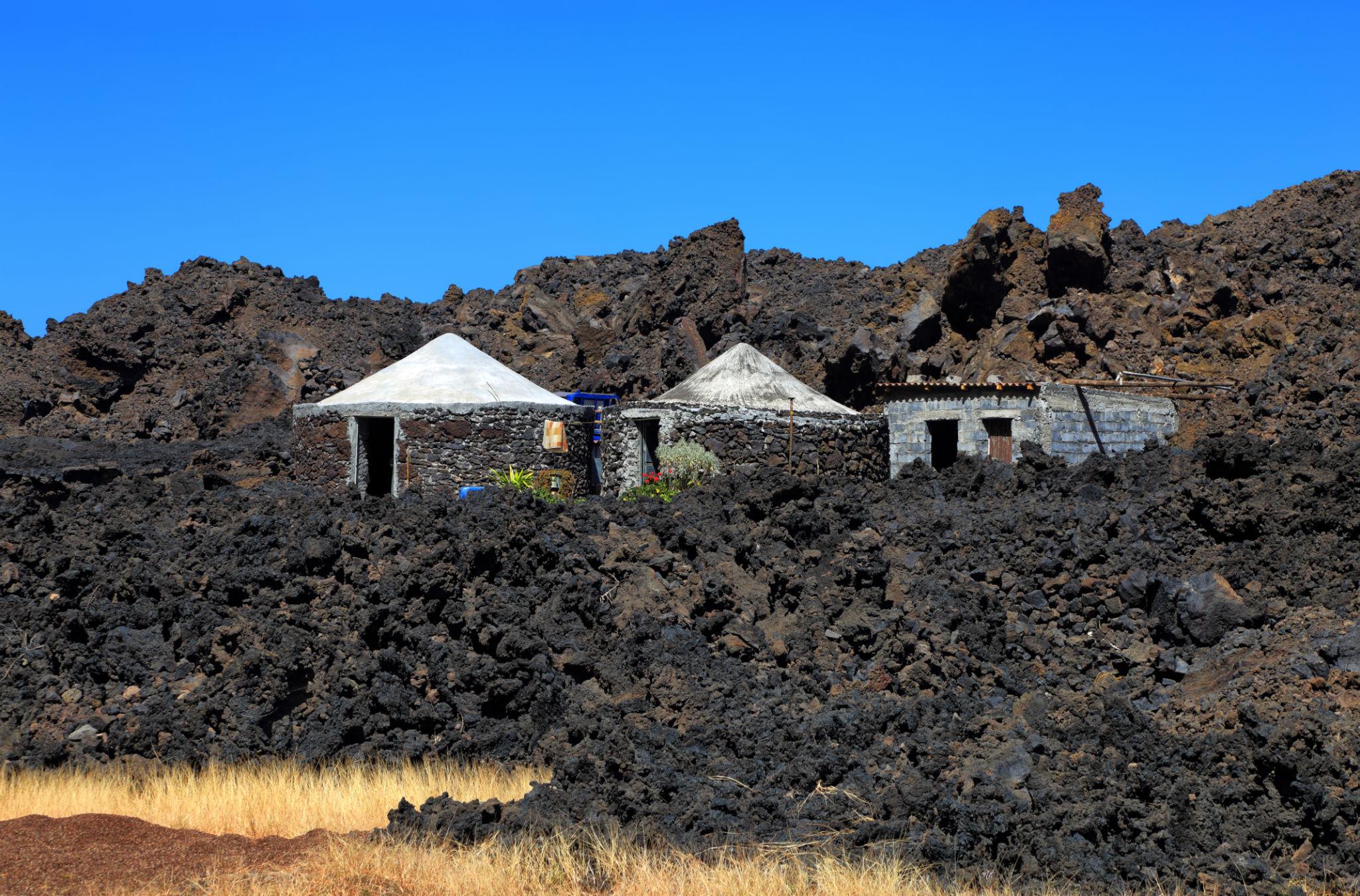 Stone eco houses among black lava fields in Fogo, Cape Verde